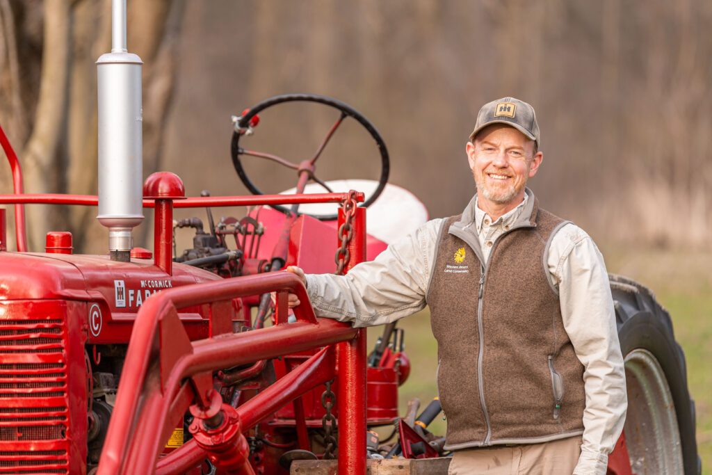 Vice President Andy McDowell stands next to his beloved 1949 Farmall C tractor