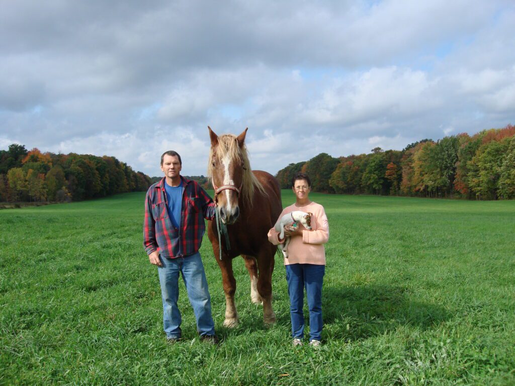 Farmers Bill and Dee Belew stand with their horse and their dog on the century farm they own and operate in Geauga County, Ohio. 